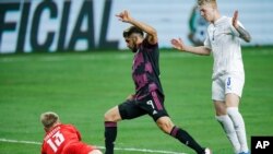 Iceland midfielder Hordur Ingi Gunnarsson (3) looks on as goalkeeper Runar Alex Runarsson (13) stops a shot by Mexico forward Henry Martin (9) during the second half of an international friendly soccer match, May 29, 2021, in Arlington, Texas. 