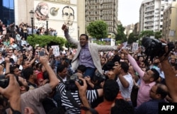 FILE - Khaled Elbalshy demonstrates with fellow journalists outside the Journalists Syndicate headquarters in Cairo, May 4, 2016, following the arrests of two reporters.