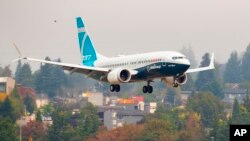 A Boeing 737 Max lands at Boeing Field in Seattle, Sept. 30, 2020. 