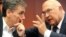 French Finance Minister Michel Sapin talk to Greek Finance Minister Euclid Tsakalotos, left, during a meeting of eurozone finance ministers at the EU Council building in Brussels, Aug. 14, 2015. 
