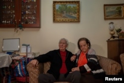Ioanna Matsouka, 93, and her husband Kostas Matsoukas pose for a picture in their house in Athens, Greece, March 6, 2024. (REUTERS/Karolina Tagaris)