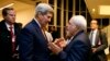 FILE - Secretary of State John Kerry talks with Iranian Foreign Minister Mohammad Javad Zarif in Vienna, after the International Atomic Energy Agency (IAEA) verified that Iran has met all conditions under the nuclear deal. 