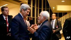 FILE - Secretary of State John Kerry talks with Iranian Foreign Minister Mohammad Javad Zarif in Vienna, after the International Atomic Energy Agency (IAEA) verified that Iran has met all conditions under the nuclear deal. 