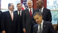 President Obama signs the Korea Free Trade Agreement at the White House, Friday. Behind him, from left, are Andrew Liveris, chief of Dow Chemical, Secretary of Agriculture Tom Vilsack, Jim McNerney, chief executive officer of Boeing and Ron Kirk, U.S. Tr