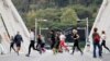 FILE - Women jog on Ponte della Musica during an exercise class, as the spread of the coronavirus disease (COVID-19) continues in Rome, Italy, Nov. 2, 2020. 