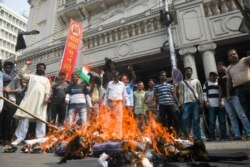 All India Youth League activists burn an effigy of Indian Minister of Home Affairs Amit Shah during a protest against India's new citizenship law and Shah's presence at a political rally in Kolkata, March 1, 2020, after sectarian riots in New Delhi.
