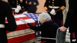 Annie Glenn menyentuh peti jenazah suaminya, John Glenn, saat disemayamkan di Ohio Statehouse di Columbus, 16 Desember 2016. 