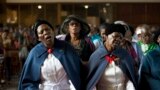 Women sing during a mass commemorating the late South African former President Nelson Mandela in Soweto, near Johannesburg. 