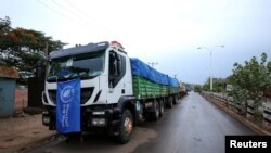 FILE - The World Food Program (WFP) convoy trucks carrying food items for the victims of Tigray war are seen parked after the checkpoints leading to Tigray Region were closed, in Mai Tsebri town, Ethiopia, June 26, 2021.