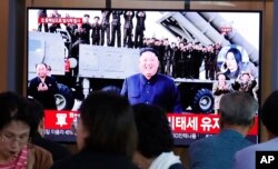 People watch a TV showing a file image of North Korean leader Kim Jong Un during a news program at the Seoul Railway Station in Seoul, South Korea, Oct. 2, 2019.