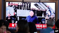 People watch a TV showing a file image of North Korean leader Kim Jong Un during a news program at the Seoul Railway Station in Seoul, South Korea, Oct. 2, 2019.