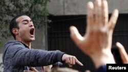 Activist Ahmed Doma shouts slogans against Egyptian President Mohamed Morsi and the Muslim Brotherhood during the funeral of activists Mohamed el-Gendy and Amr Saad in Cairo February 4, 2013.