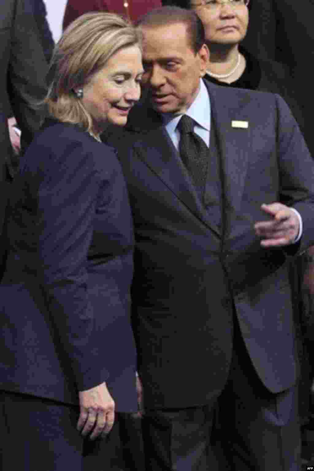 Italy's Prime Minister Silvio Berlusconi, right, talks with U.S. Secretary of State Hillary Rodham Clinton at the start of the OSCE Summit at the Palace of Independence in Astana, Kazakhstan, Wednesday Dec. 1, 2010. The OSCE Summit, the first ever to be h