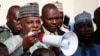 Borno state governor, Kashim Shettima, centre, addresses demonstrators who were calling on the government to rescue the kidnapped schoolgirls of the Chibok secondary school, in Abuja, Nigeria, May 13, 2014.