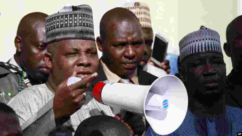 Borno state governor, Kashim Shettima, centre, addresses demonstrators who were calling on the government to rescue the kidnapped schoolgirls of the Chibok secondary school, in Abuja, Nigeria, May 13, 2014.