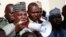 Borno state governor, Kashim Shettima, centre, addresses demonstrators who were calling on the government to rescue the kidnapped schoolgirls of the Chibok secondary school, in Abuja, Nigeria, May 13, 2014.