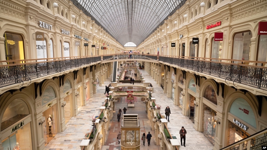 FILE - Small number of visitors walk inside the GUM department store in Moscow, Russia on March 4, 2022. (AP Photo, File)