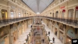 FILE - Small number of visitors walk inside the GUM department store in Moscow, Russia on March 4, 2022. (AP Photo, File)