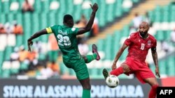 FILE - Emilio Nsue (R) fights for the ball with Guinea-Bissau's defender #20 Sori Mane during the AFCON 2024 group A football match between Equatorial Guinea and Guinea-Bissau.