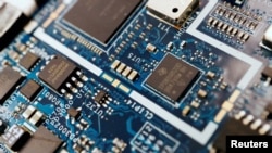 FILE - Semiconductor chips are shown on a circuit board. An updated rule curbing exports of U.S. chipmaking equipment to China is in the final stages of review, a U.S. government agency posting said on Oct. 5, 2023.