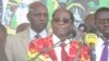 Zimbabwe President Robert Mugabe addresses members of his Zanu PF party at a football stadium in Lupane, about 600 km southwest of Zimbabwe's capital Harare (S. Mhofu/VOA)