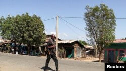 FILE - A member of the Amhara Special Force patrols a street in Soroka village in Amhara region near a border with Tigray, Ethiopia, Nov. 9, 2020. 