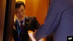 FILE - In this image made from video, Chen Xuyuan, head of the Chinese Football Association, gets on an elevator in Shanghai, Oct. 24, 2019.