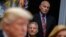 White House chief of staff John Kelly (standing) listens as President Donald Trump speaks during a meeting on tax policy with business leaders in the Roosevelt Room of the White House, Oct. 31, 2017.