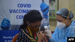 21일 인도 실리구리 한 클럽에서 의료진이 주민에게 신종 코로나바이러스 백신을 접종하고 있다.