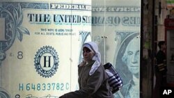 An Egyptian walks in front of a closed currency exchange office as banks, schools and the stock market remained closed for the second working day in Cairo, Egypt, January 31, 2011