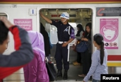 A security personnel stand guard inside train carriage for women at Manggarai train station in Jakarta, Jan. 8, 2016.