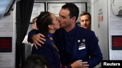 Crew members Paula Podest and Carlos Ciufffardi kiss after being married on board by Pope Francis during the flight between Santiago and the northern city of Iquique, Jan. 18, 2018. 