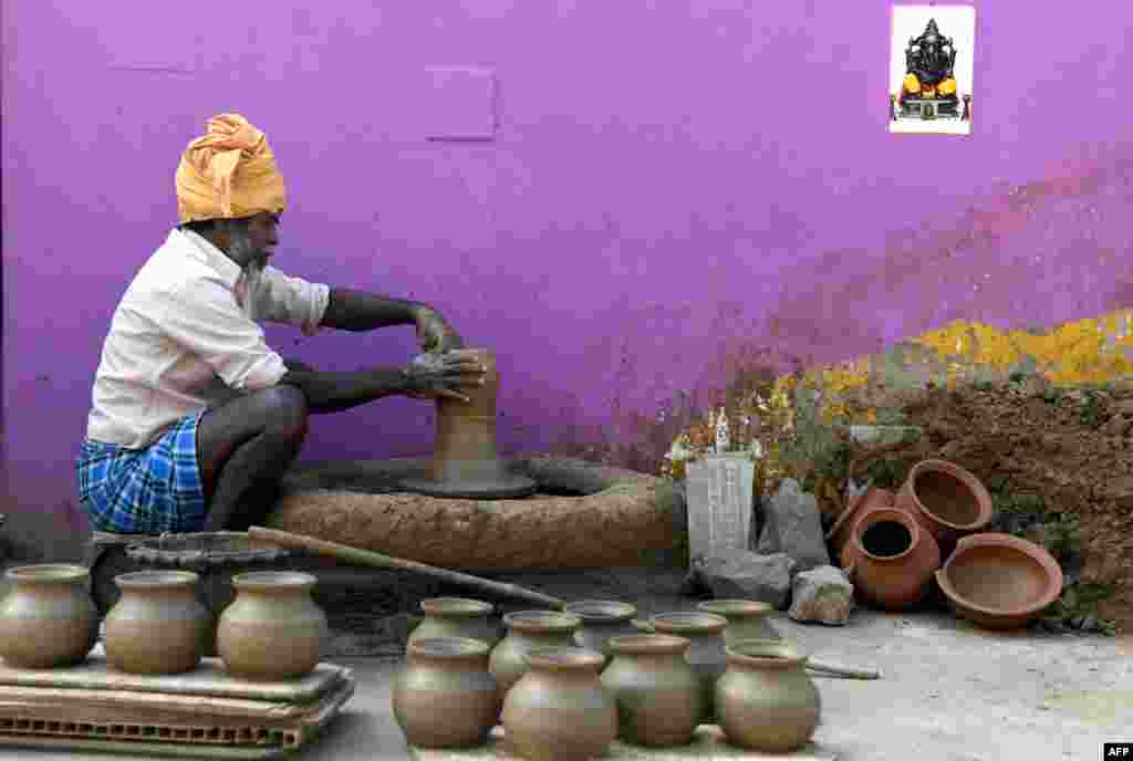 A potter makes earthen pots ahead of the Hindu Pongal festival, or Makar Sankranti, in a village on the outskirts of Chennai, India.