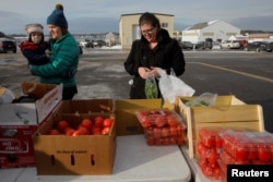 Members of the U.S. Coast Guard working without pay during the government shutdown and their families pick up produce, eggs, milk, bread and other supplies being distributed by Gather food pantry at the U.S. Coast Guard Portsmouth Harbor base in New Castle, New Hampshire, U.S., Jan. 23, 2019.