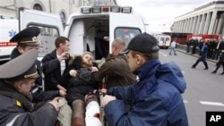 A wounded blast victim is brought by rescuers to an ambulance vehicle in Minsk, Belarus, April 11, 2011
