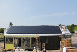 Professional builders worked with students to construct the solar-powered house.