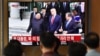 FILE - People watch a television news screen showing U.S. President Donald Trump, South Korean Moon Jae-in and North Korean leader Kim Jong Un meeting at the truce village of Panmunjom in the DMZ, at a railway station in Seoul, June 30, 2019. 