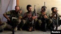 Members of the Syrian Democratic Forces keep guard at their advanced position during fighting with Islamic State militants in Raqqa, Syria. (Reuters)
