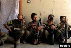 Members of the Syrian Democratic Forces keep guard at their advanced position during fighting with Islamic State militants in Nazlat Shahada, a district of Raqqa, Syria, Aug. 16, 2017.