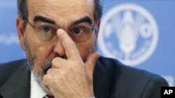 Jose Graziano da Silva, director-general of UN's Food and Agriculture Organization (FAO), adjusts his glasses as he leads a news conference at the FAO headquarters in Rome, Jan. 3, 2012.
