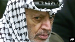 FILE - Palestinian leader Yasser Arafat pauses during the weekly Muslim Friday prayers in his headquarters in the West Bank city of Ramallah, May 31, 2002.