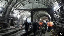 In this photo taken on July 15, 2014 rescuers carry a stretcher with a victim from a tunnel after a train derailed between two subway stations in Moscow, Russia.