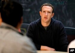 FILE - Facebook CEO Mark Zuckerberg meets with entrepreneurs and innovators during a round-table discussion in St. Louis, Nov. 9, 2017.