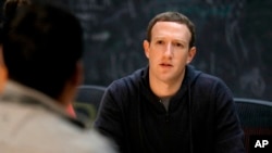 FILE - Facebook CEO Mark Zuckerberg meets with entrepreneurs and innovators during a round-table discussion in St. Louis, Nov. 9, 2017.