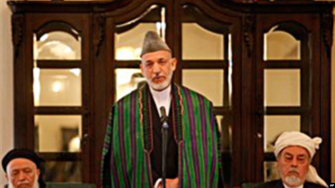 Afghan President Hamid Karzai, center, speaks during the inaugural session of Afghanistan's new peace council in Kabul, Afghanistan, 7 Oct. 2010