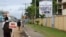 FILE - People walk past the headquarters of Liberia's National Elections Commission (NEC) in the Sinkor neighborhood of Monrovia, Liberia Nov. 6, 2017. 