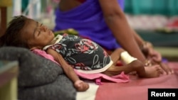 An infant lies in bed in a malnutrition intensive care unit in Dharbhanga, India, April 16, 2015. Researchers thought stunting was mostly caused by malnutrition, but a study indicates a parasite may be a factor.