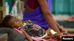 An infant lies in bed in a malnutrition intensive care unit in Dharbhanga, India, April 16, 2015. Researchers thought stunting was mostly caused by malnutrition, but a study indicates a parasite may be a factor.
