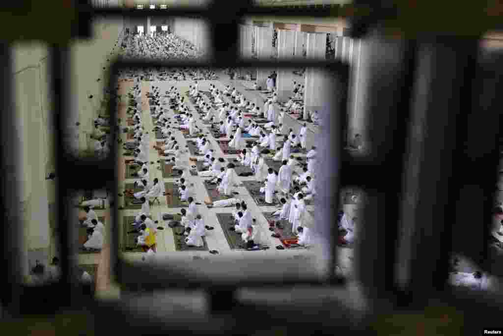 Muslim pilgrims pray as others sit at Namira Mosque on the plain of Arafat during the annual Haj pilgrimage as the country barred worshipers from abroad for a second year due to the COVID-19 pandemic, outside the holy city of Mecca, Saudi Arabia.