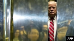 FILE - Donald Trump boards the elevator at Trump Tower in New York City, Jan. 16, 2017.